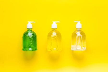 Sanitizer - bottle with dispenser - on yellow background top view.の写真素材