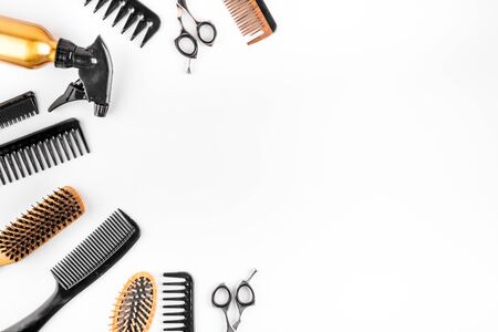 Hairdressing instruments. Combs, scissors on white table top view.の写真素材