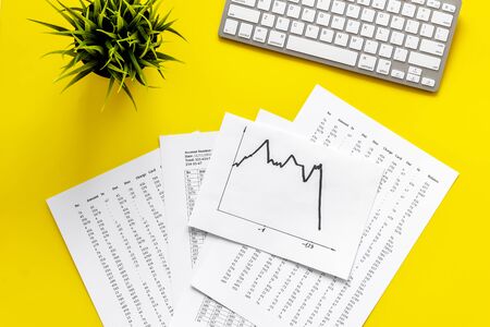 World financail crisis - arrow down, markets crash - on yellow office desk top view.の写真素材