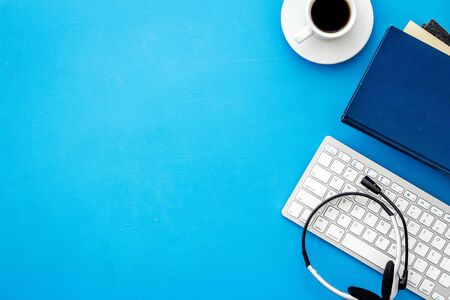 Online education. Books, computer and headphones on blue background top-down flat lay copy spaceの写真素材