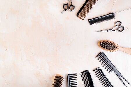 Hairdressing instruments. Combs, scissors on beige table top view.の写真素材