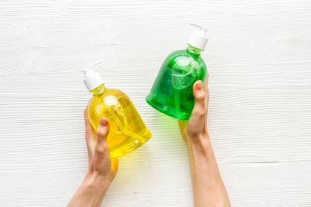 Sanitizer bottle in hands - coronavirus prevention - on white background top viewの写真素材