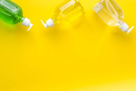 Coronavirus prevention - disifecting gel - on yellow desk from above copy spaceの写真素材