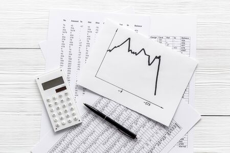 Financail crisis - business grahp, markets crash - on white wooden background top-downの写真素材