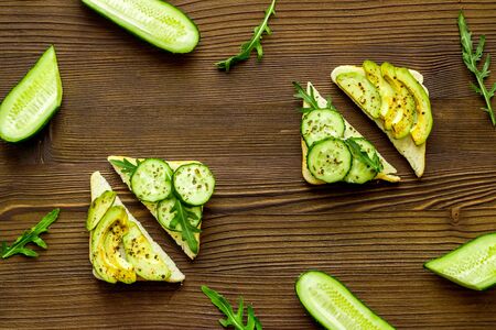 vegan avocado sandwiches on wooden desk top view patternの写真素材