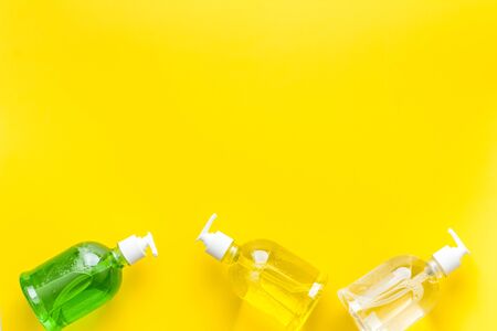 Coronavirus prevention - disifecting gel - on yellow desk from above copy spaceの写真素材