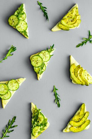 vegan avocado sandwiches on grey desk top view patternの写真素材