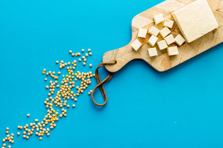 Tofu cubes with soybeans top view copy space