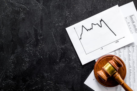 Debts - judge gavel, crisis graph - on black desk top-down copy spaceの写真素材