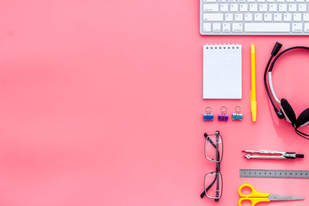 Education online school concept. Stationery, keyboard on pink table top view flat lay copy spaceの写真素材