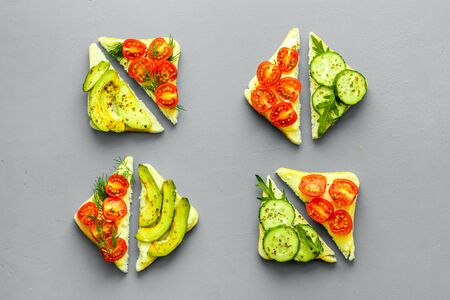set of avocado sandwiches on grey background top-down patternの写真素材