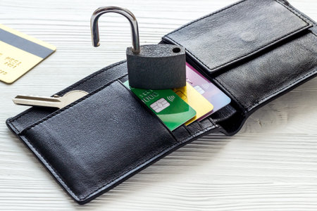 credit card hacked - security lock open and wallet - on white table