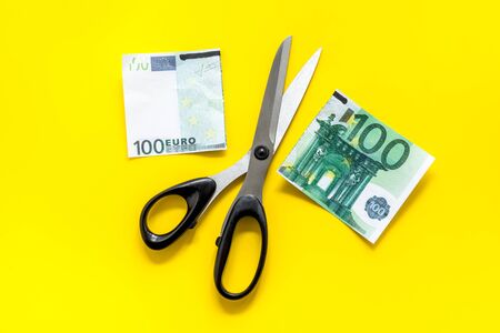 Decline of euro exchange rate. Scissors cut dollars banknoteの写真素材