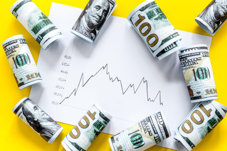 Stock market chart with US dollars banknote top view