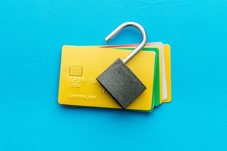 credit card hacked. open lock on blue table from aboveの写真素材
