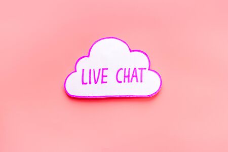 Live chat communication concept - words on pink background top viewの写真素材