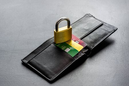 Credit card security concept with lock, wallet on grey deskの写真素材