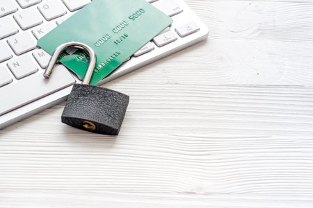 credit card hacked. keyborard, open lock on white background copy space