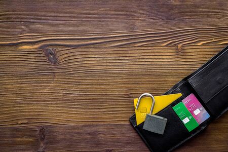 Credit card data security concept with lock on wooden desk top view copy space