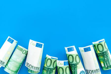 A lot of euro banknote on blue background top viewの写真素材