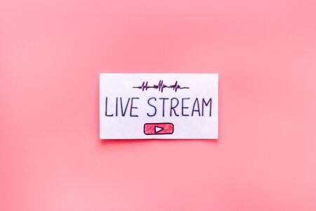Live streaming concept - words on paper tablet on pink top viewの写真素材