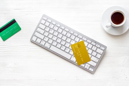 shopping online payment. Card on keyboard on white desk top-down