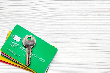 Credit card security concept with key on white desk top-down copy spaceの写真素材