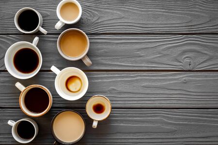 Coffee addiction. Many of cups on wooden table top view space for textの写真素材