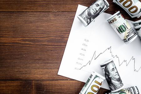 Diagram of stock market prices rates with US dollars banknote top viewの写真素材