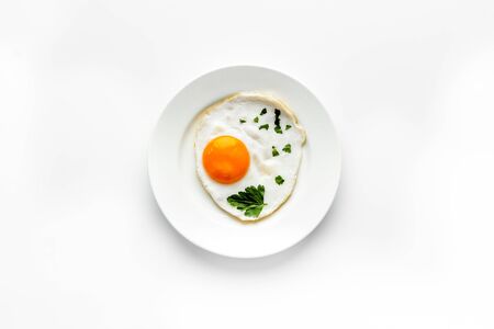 Fried eggs on plate - white kitchen table top-downの写真素材