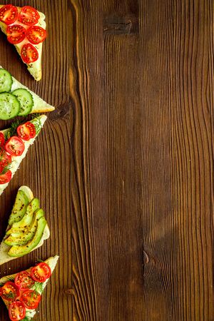 cooking green avocado toasts on wooden table top view frame copy spaceの写真素材