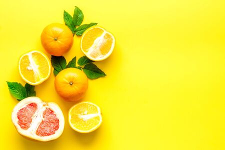 Citrus fruits on yellow background top viewの写真素材