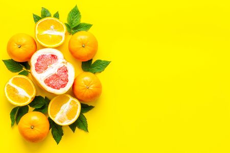 Oranges and grapefruits with leaves on table top view copy spaceの写真素材