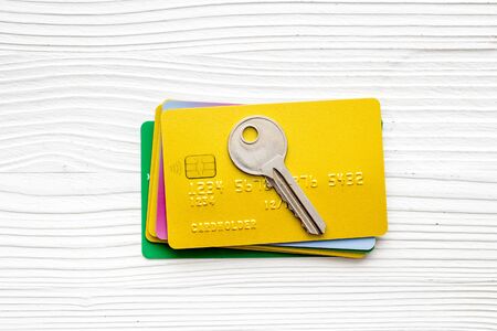 Credit card security concept with key on white desk top-down.の写真素材
