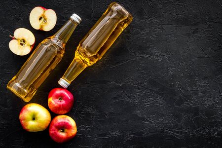 Apple cider vinegar bottle on black background top view.の写真素材