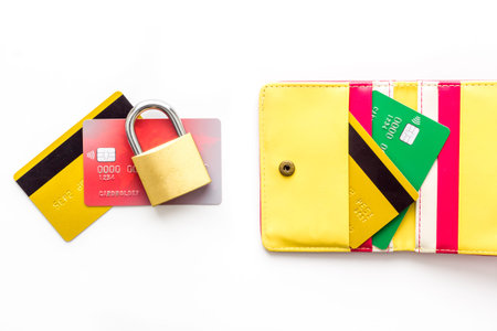 Credit card security concept with lock, wallet on white table from above.の写真素材