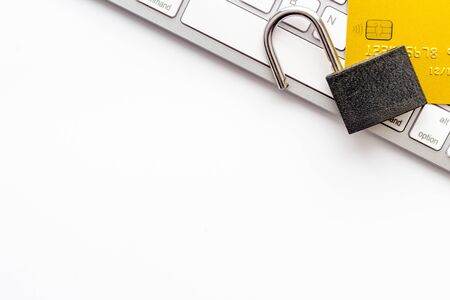 credit card hacked - keyborard, open lock - on white table top view copy space