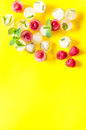 Berries and mint in ice cubes top view frame copy spaceの写真素材