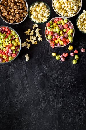 Set of flavored popcorn and soda on black desk top-down space for textの写真素材