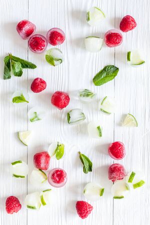 Berries frozen in ice cubes background flat layの写真素材