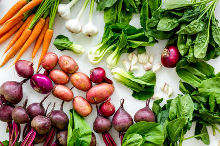 Carrot, potato, beet, onion and spinach on white background top view