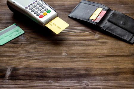 Payment by credit card. Terminal on wooden table copy spaceの写真素材