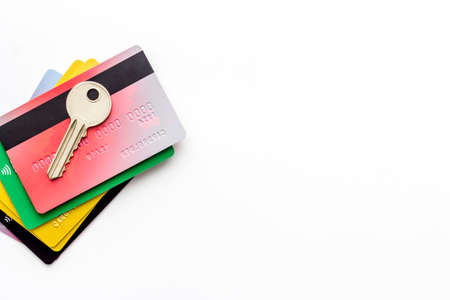 Credit card security concept with key on white desk top-down copy spaceの写真素材