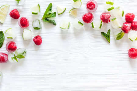 Berries and mint in ice cubes top view frame copy spaceの写真素材