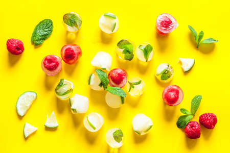 Berries frozen in ice cubes background flat layの写真素材