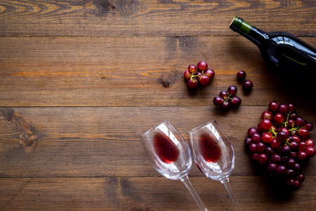 Red wine with grape - in glasses and bottle - on wooden desk top view copy spaceの写真素材