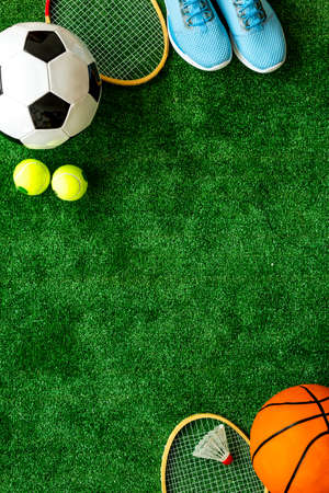 Flat lay of sport balls - football, basketball on grass top view copy spaceの写真素材