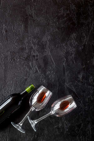 Wine bottle and glasses on black background from above copy spaceの写真素材