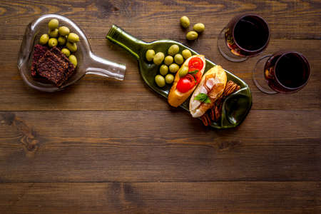 Toasts with prosciutto and tomatoes with red wine top view space for texの写真素材