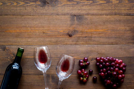 Red wine with grape - in glasses and bottle - on desk top view copy spaceの写真素材